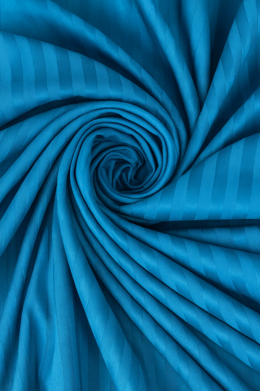 Blue fabric with striped pattern, tightly rolled up