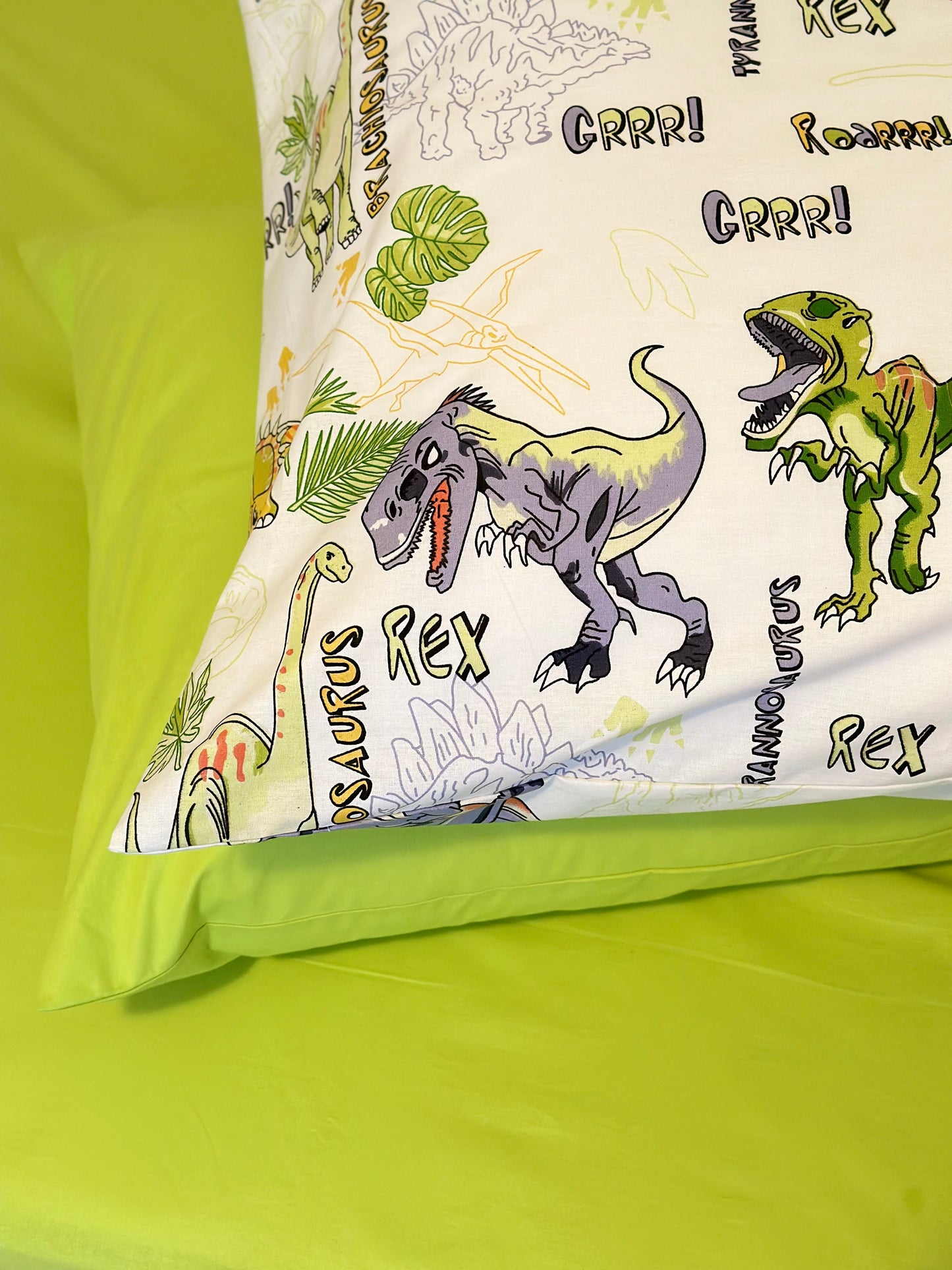 Close-up of dinosaur print on organic cotton bedding