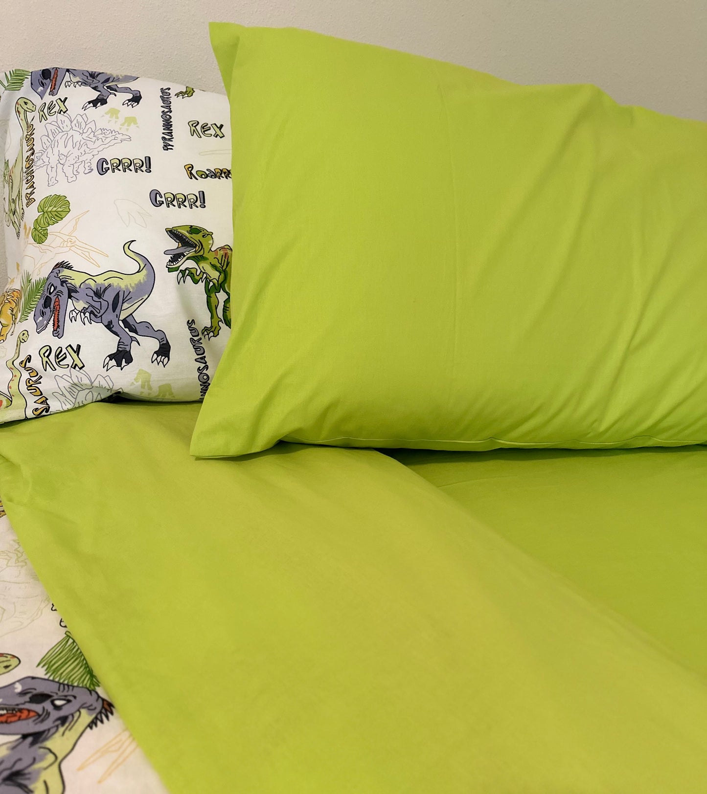 Pillowcase detail from green dinosaur bedding set