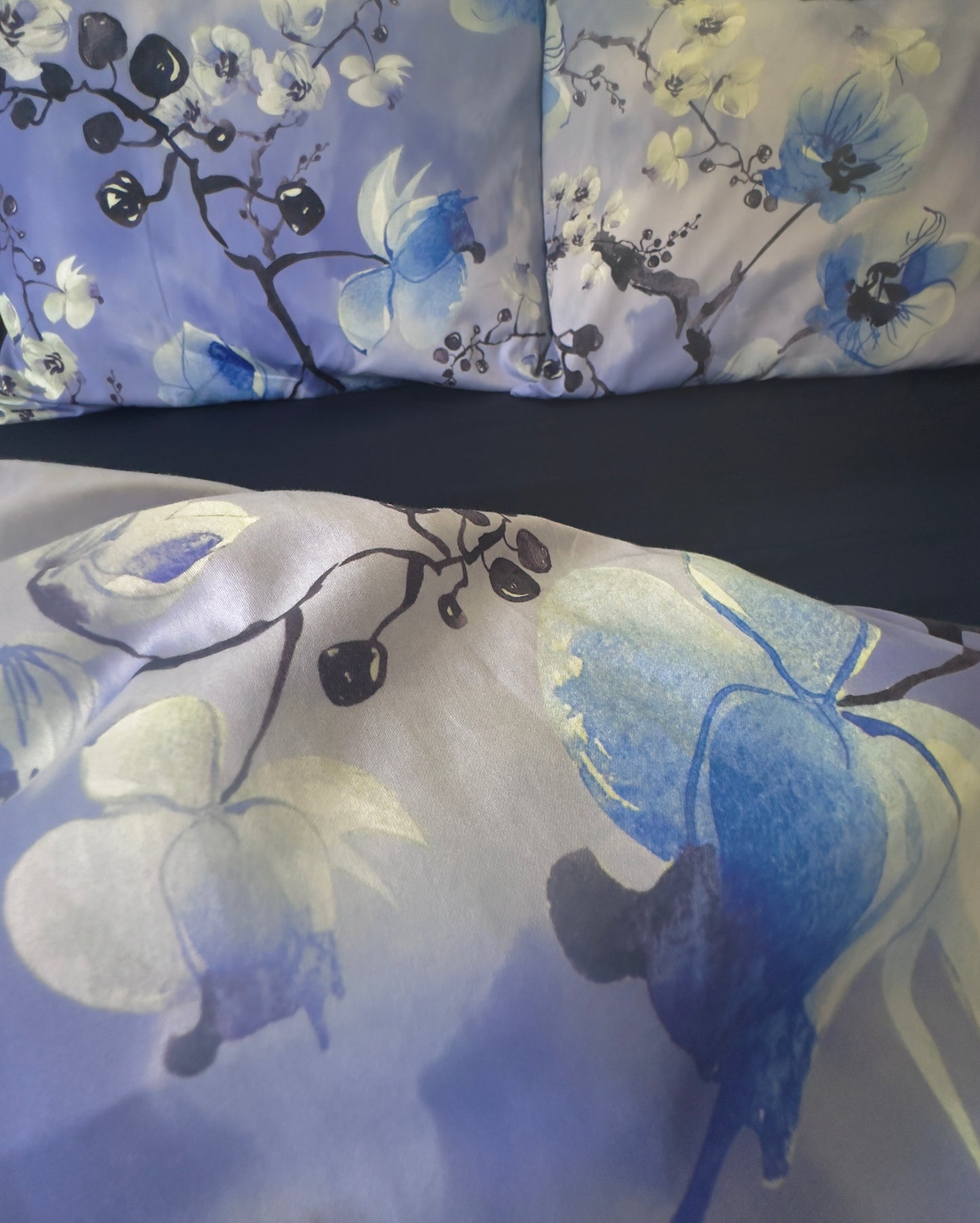Close-up of silky-smooth 100% cotton sateen fabric with floral pattern.