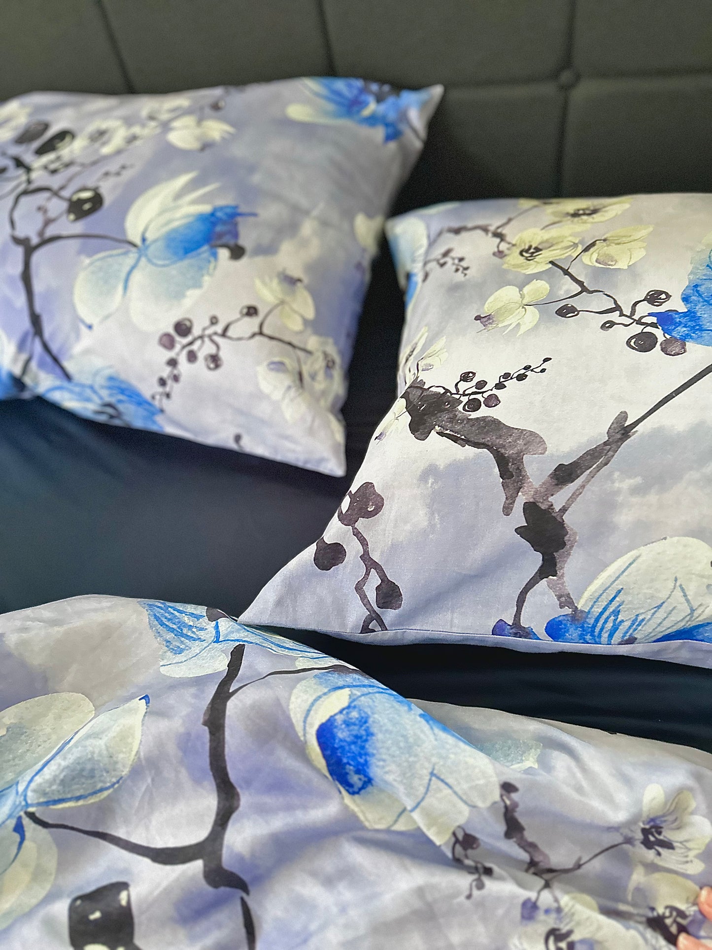 Close-up of silky sateen bedding with colorful floral patterns