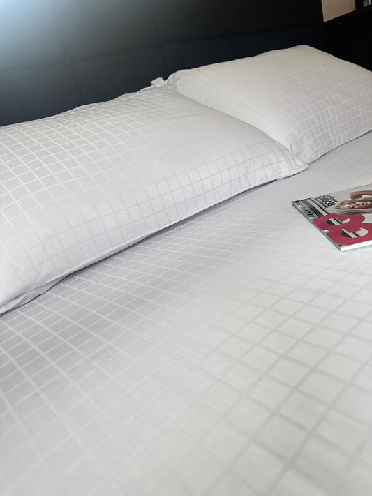 Set of two organic white jacquard sateen pillowcases made from 100% Turkish cotton.