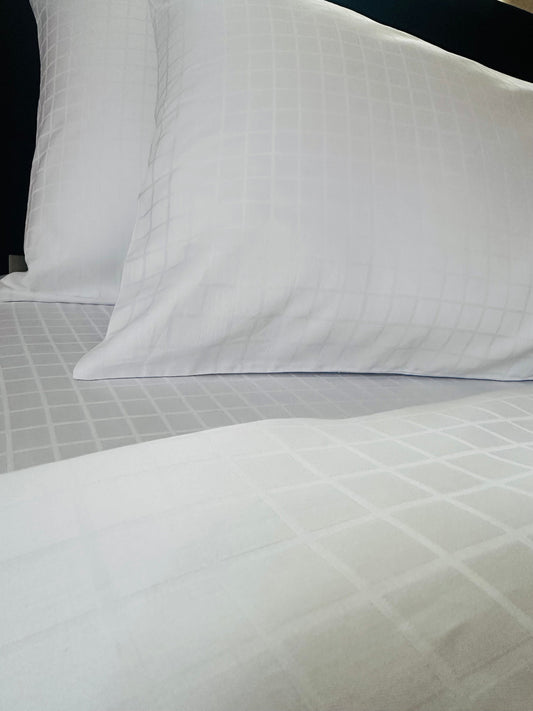 Close-up of soft and breathable organic cotton jacquard pillowcase in white.