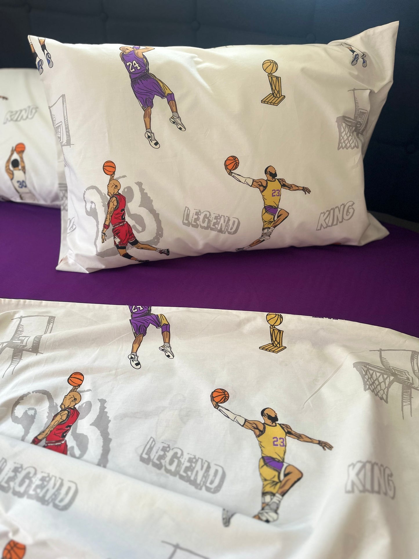 Fun basketball print pillowcases set displayed on a bed, perfect for a young fan’s room.
