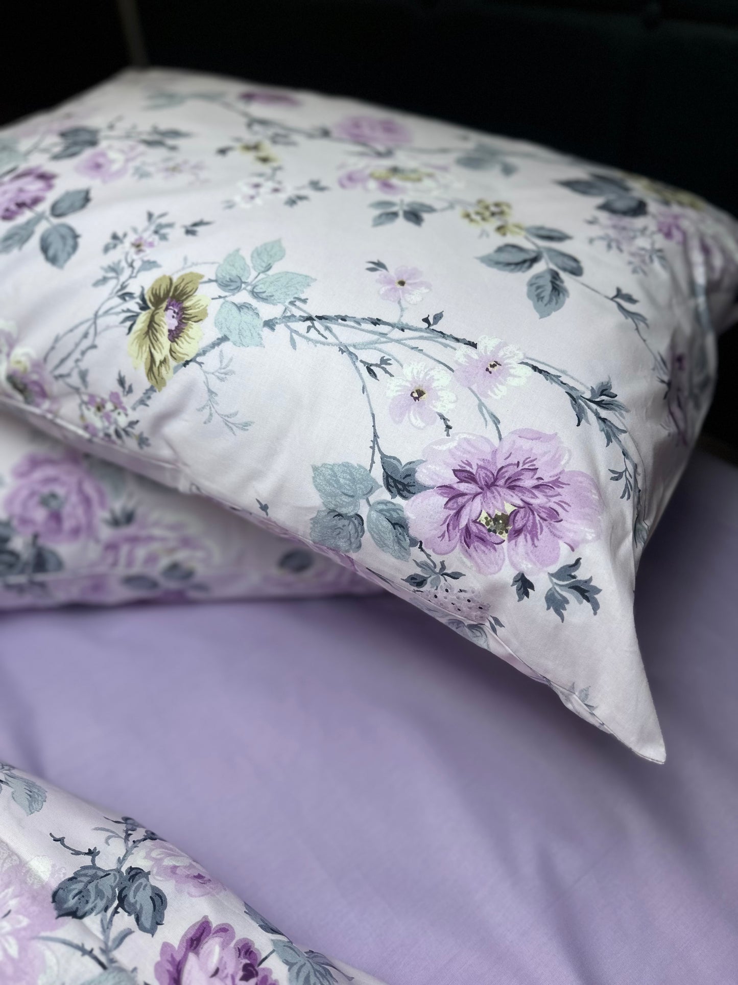 French country bedding ensemble featuring lavender floral pillowcases and a coordinating quilt