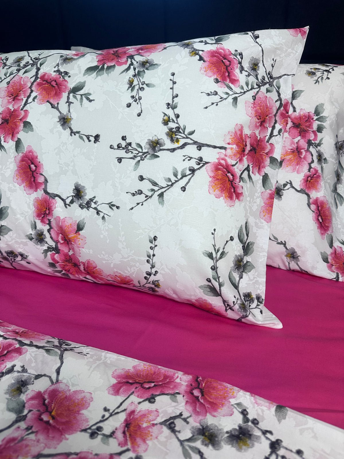 Floral-patterned fabric with pink flowers on a white background