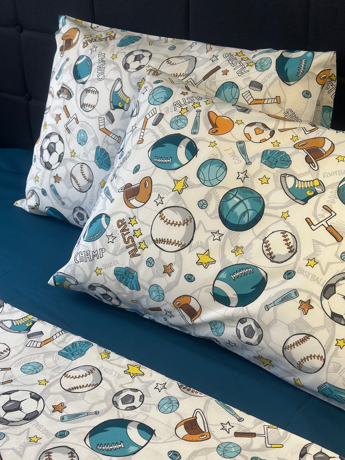 Pillowcases with sports-themed pattern on a bed