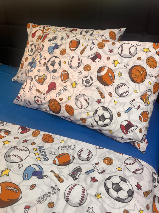 Boys sports pillowcases and bedding set with football, basketball, and baseball pattern on bed
