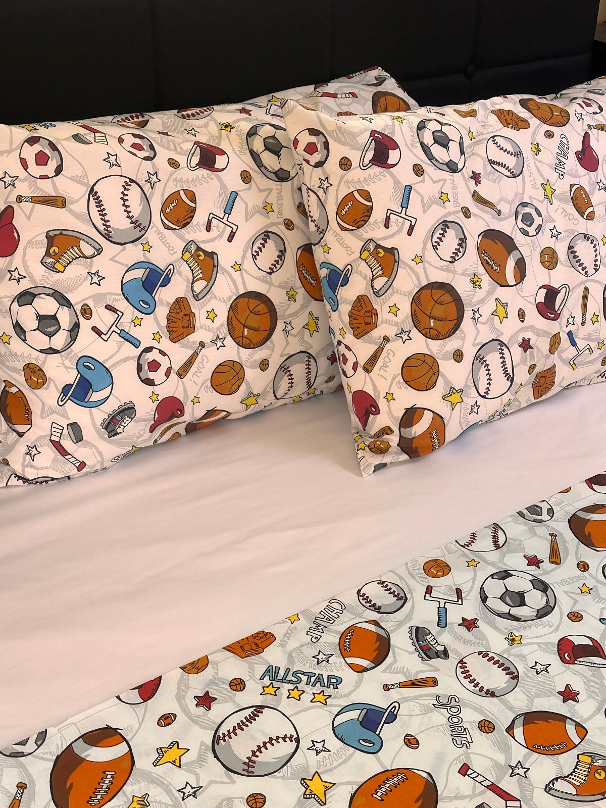 Children's pillowcases with sports-themed pattern on a white background