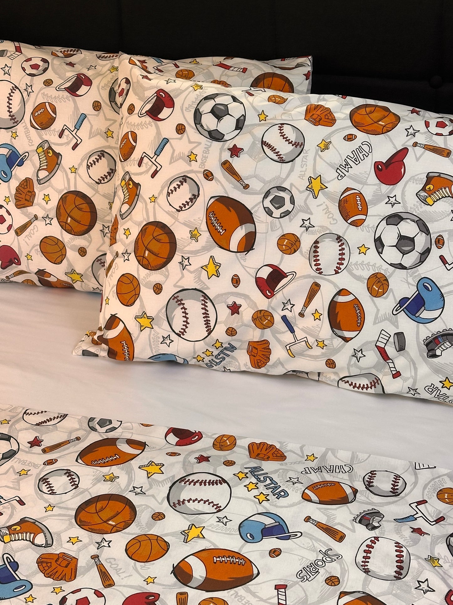 Children's bedding set with sports-themed pattern on a white background