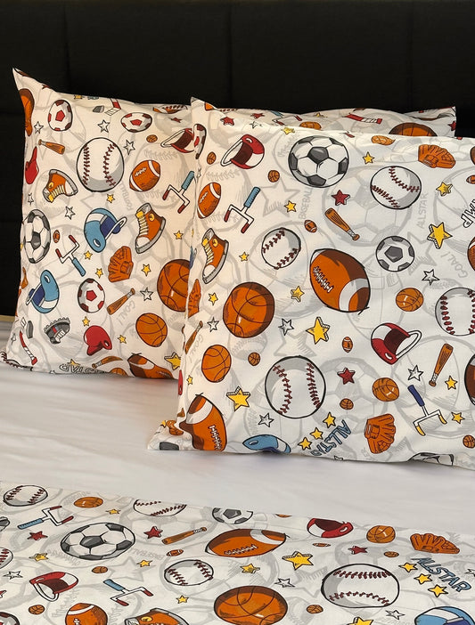 Two pillowcases with sports-themed pattern on a bed