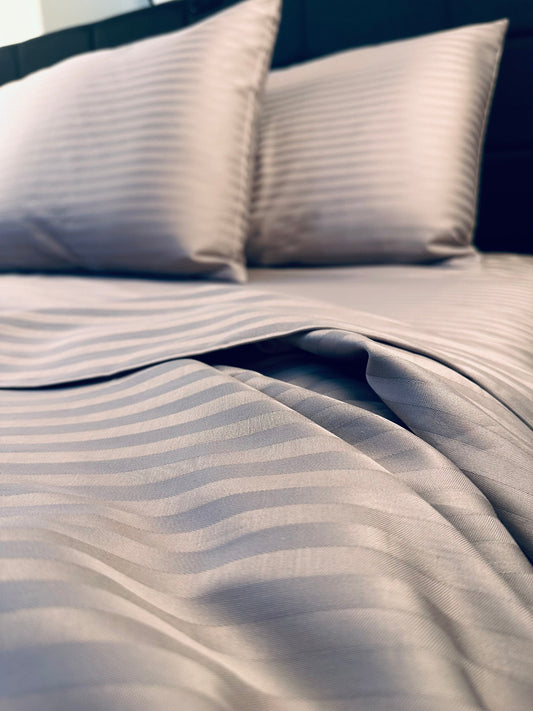Mocha brown striped sateen bedding set made of 100% cotton on a bed