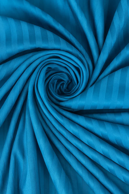 Blue fabric with striped pattern, tightly rolled up