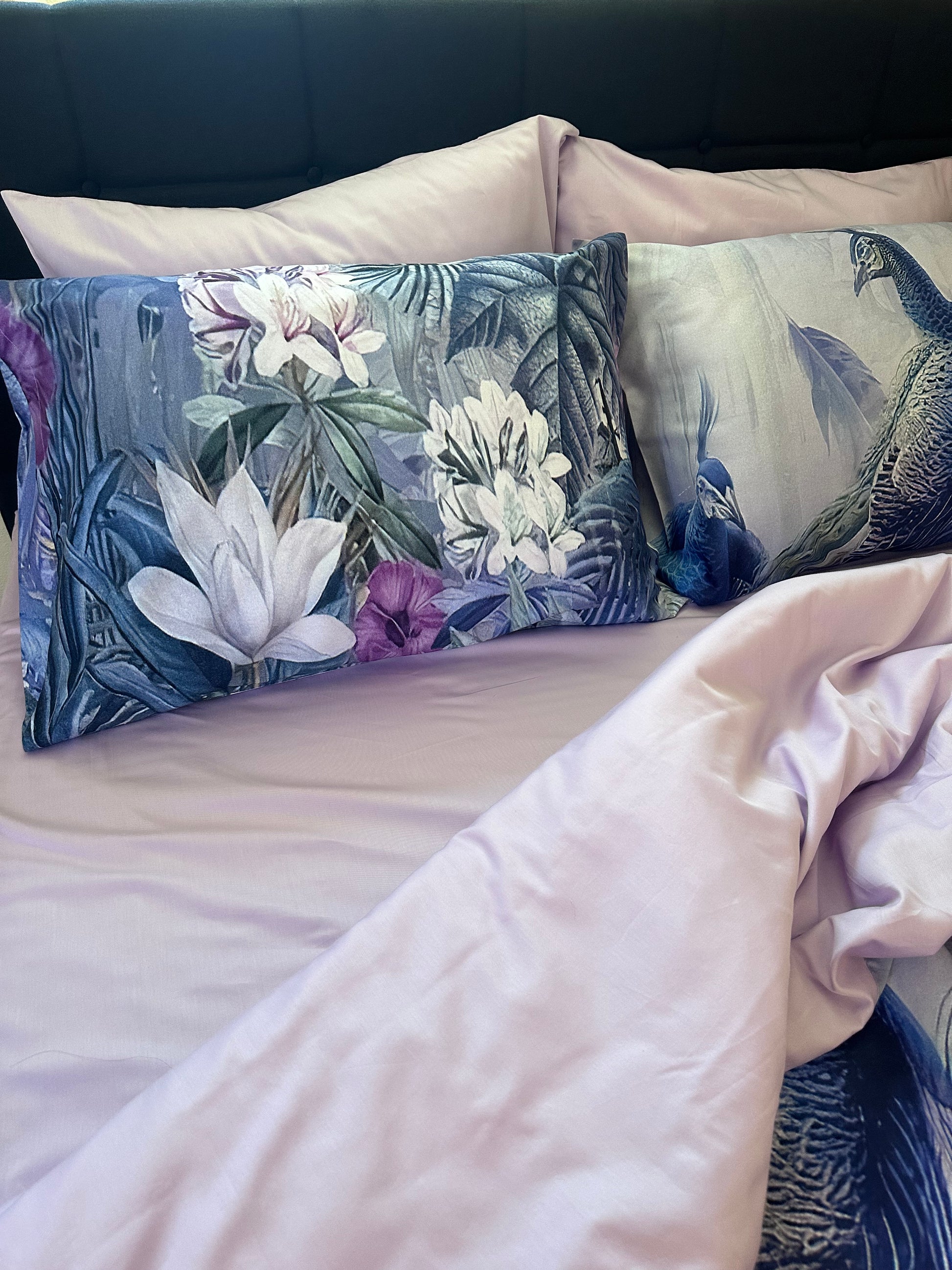 Elegant cozy bed with peacock print cotton sateen sheets and pillowcases