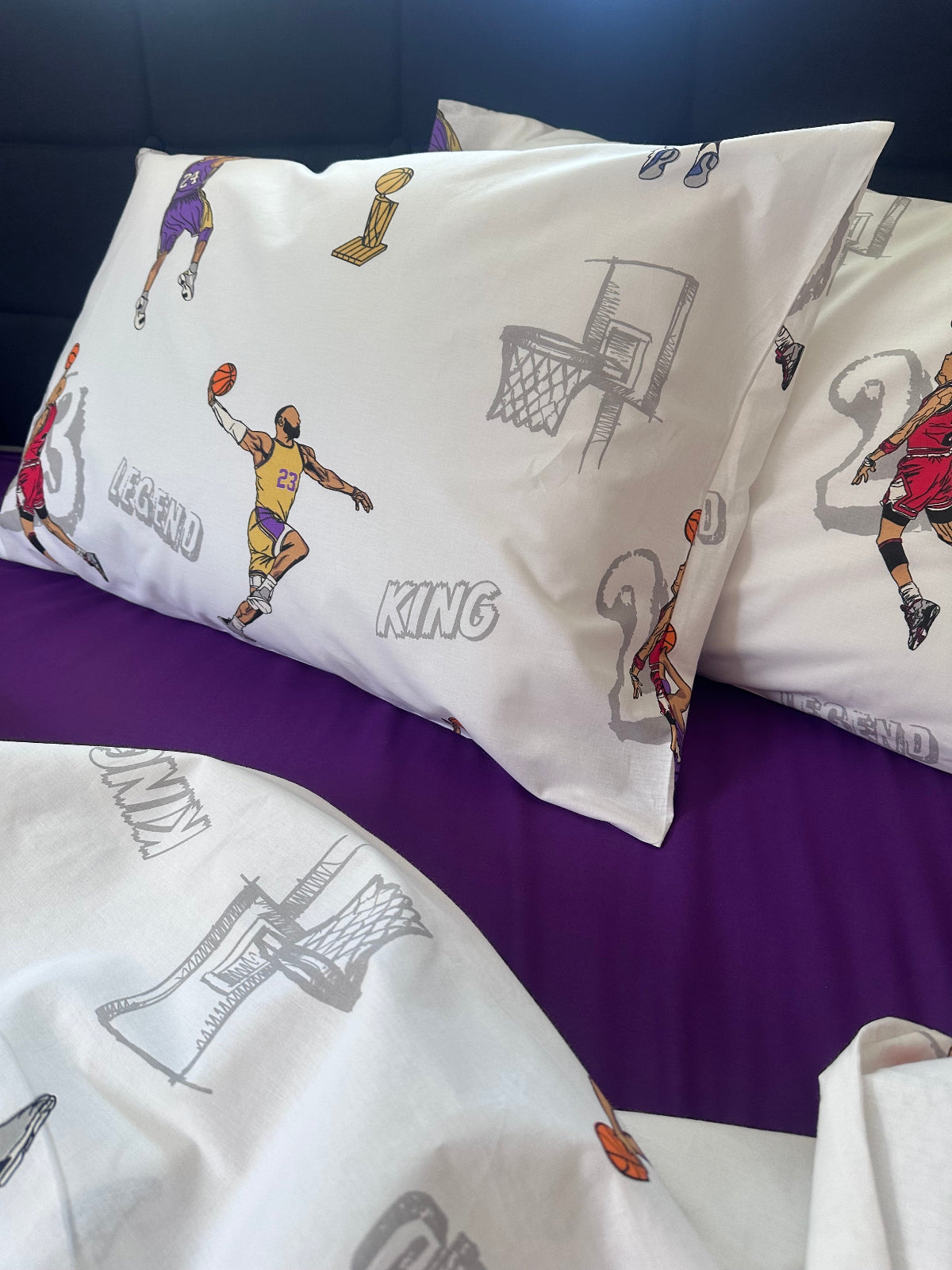 Basketball-themed pillowcases with player illustrations on a purple background