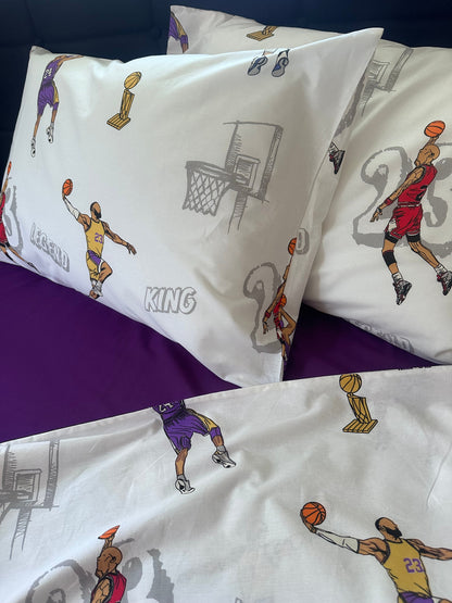 Kids’ bed styled with the basketball-themed pillowcase set (two pillows showing a player dunking and shooting).