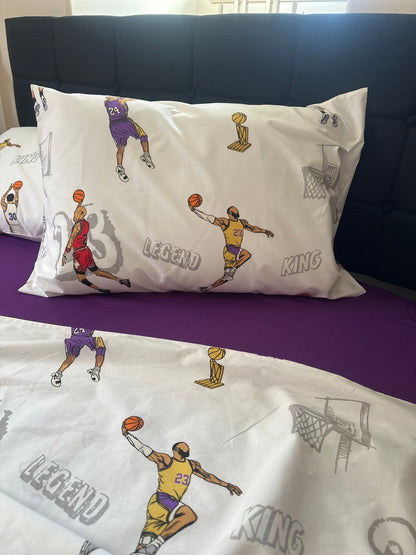Pillowcases with basketball player illustrations and text on a purple bedspread.