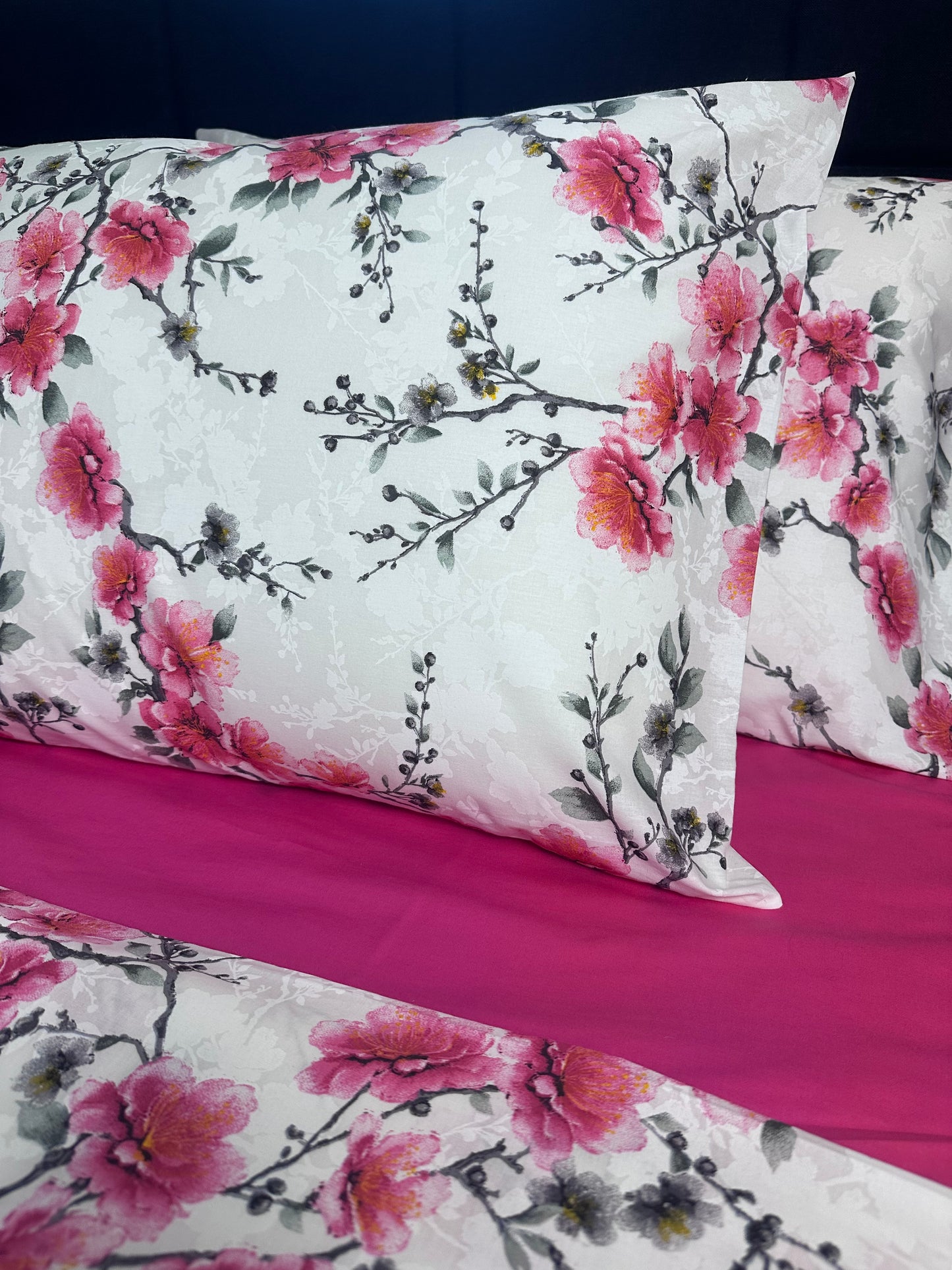 Floral-patterned fabric with pink flowers on a white background
