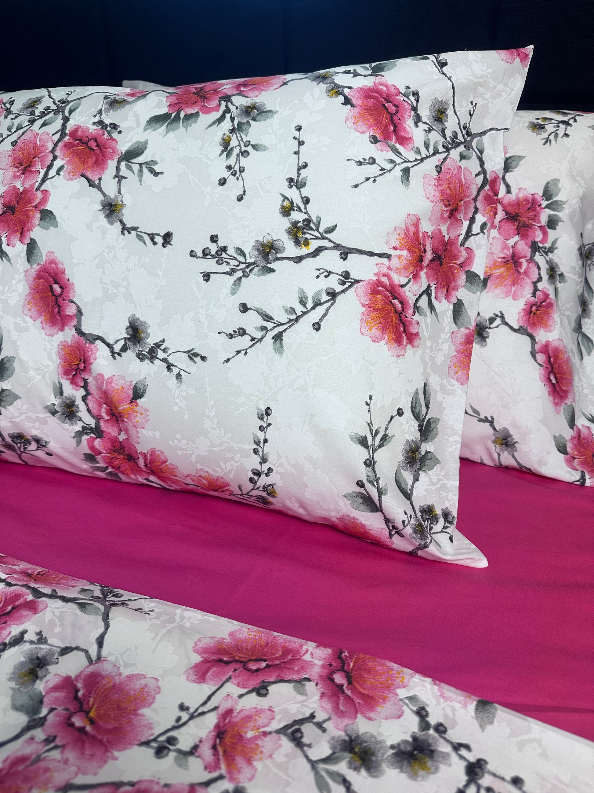 Floral-patterned fabric with pink flowers on a white background