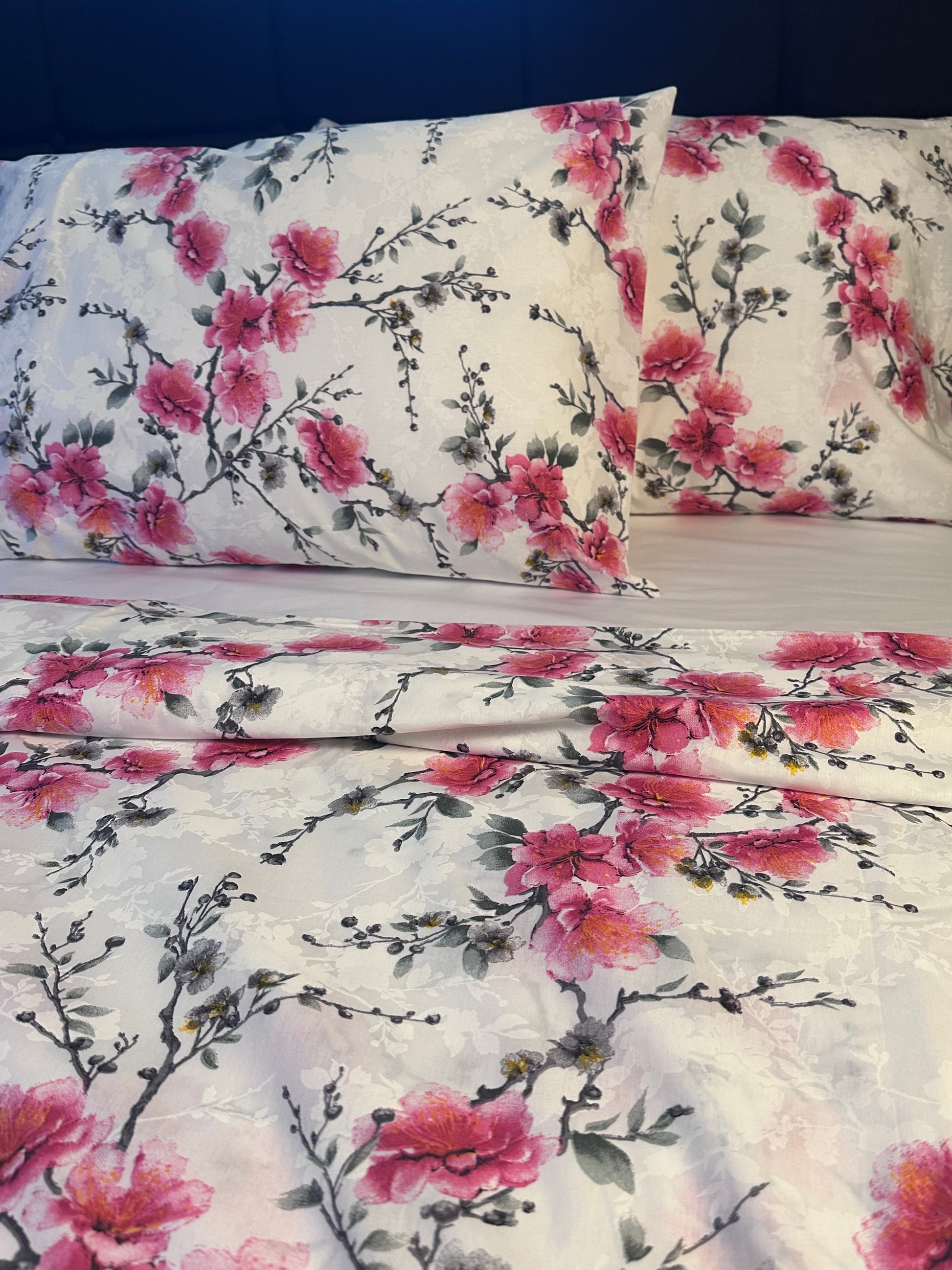 Spring-inspired cherry blossom bedding on elegant white background