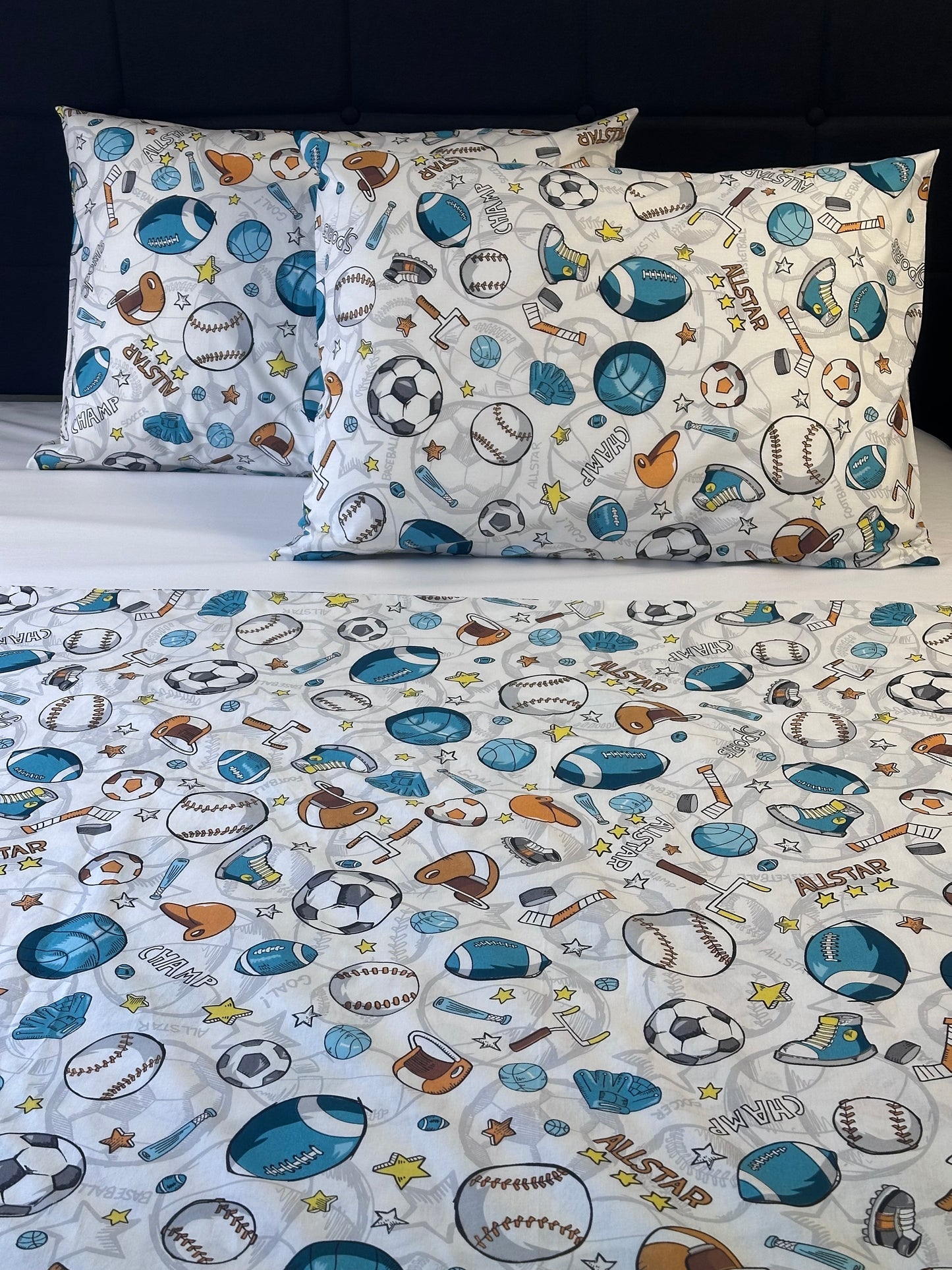 Children's bedding set with sports-themed pattern on a plain background