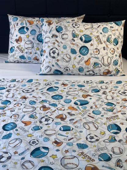Children's bedding set with sports-themed pattern on a plain background