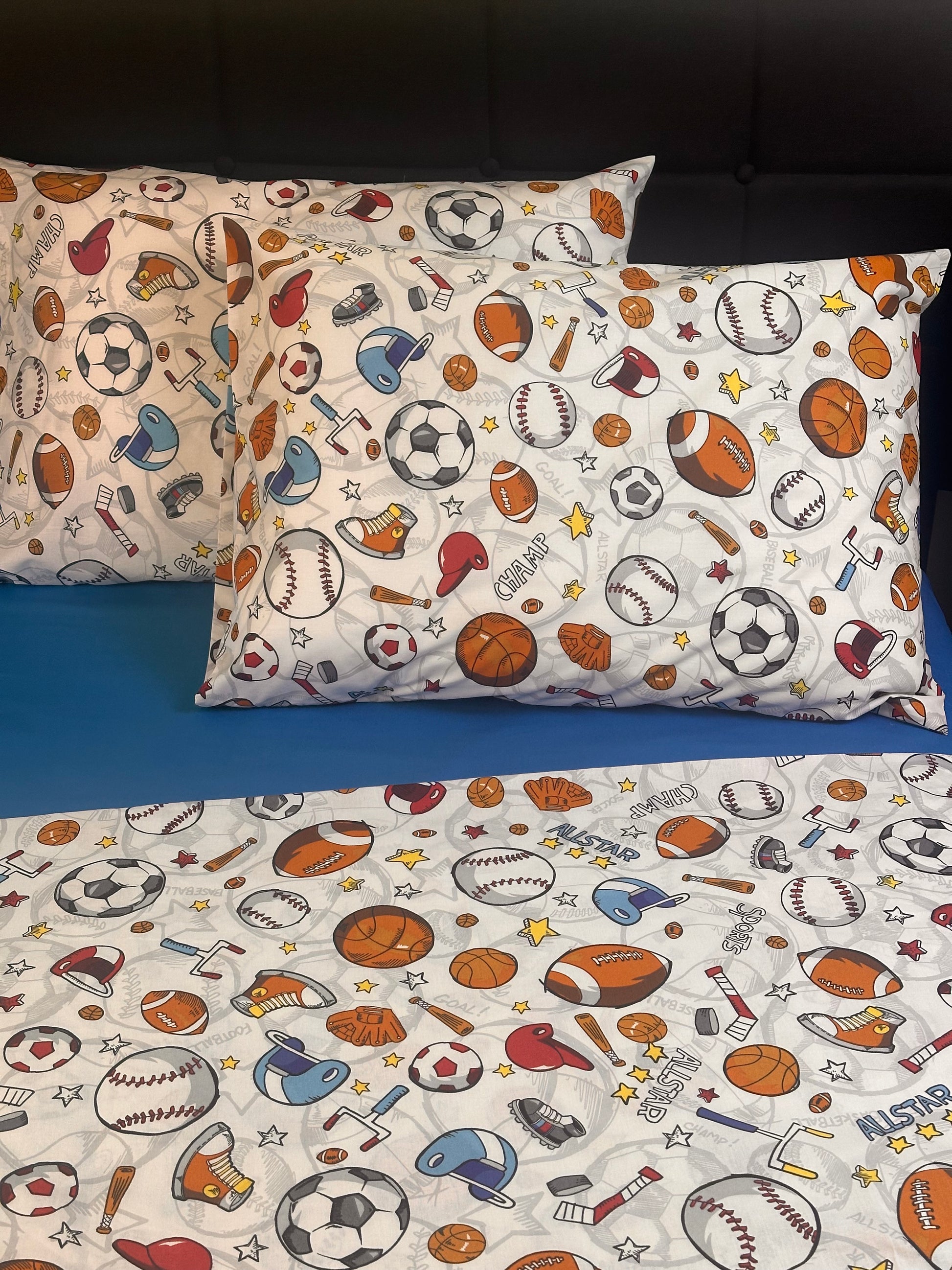 Kids sports bedding pillowcases featuring colorful athletic balls and equipment