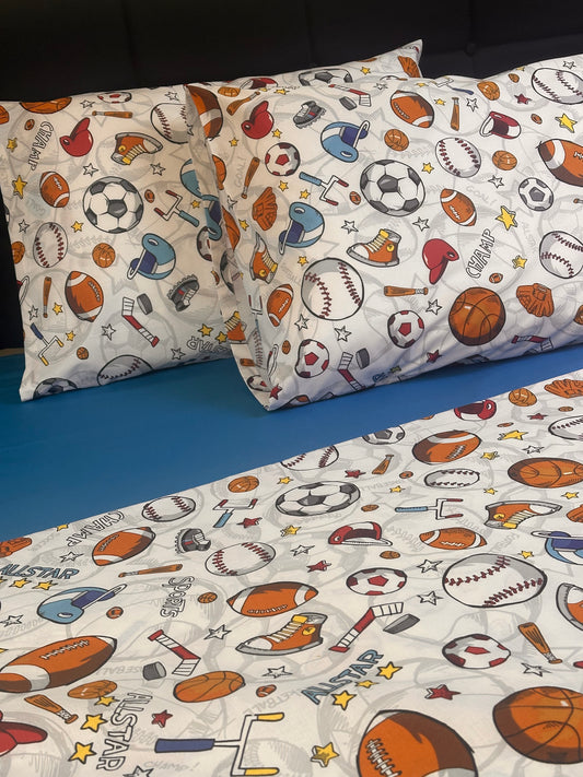 Sports themed pillowcases and bedding set with baseball, soccer, and basketball print on white background