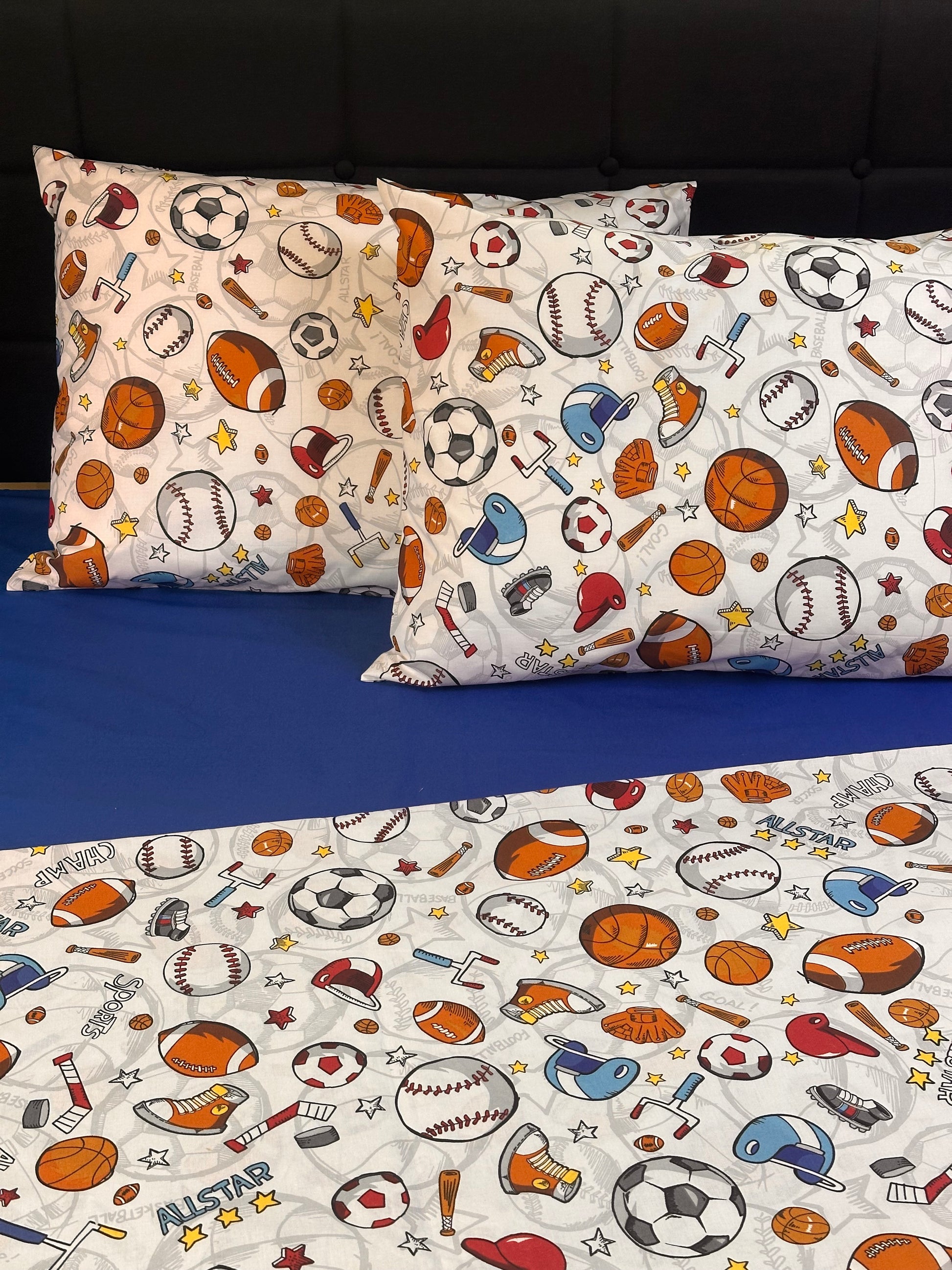 Fun boys bedroom bedding set and pillowcases with football, basketball, and hockey prints