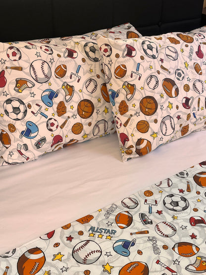 Children's pillowcases with sports-themed pattern on a white background