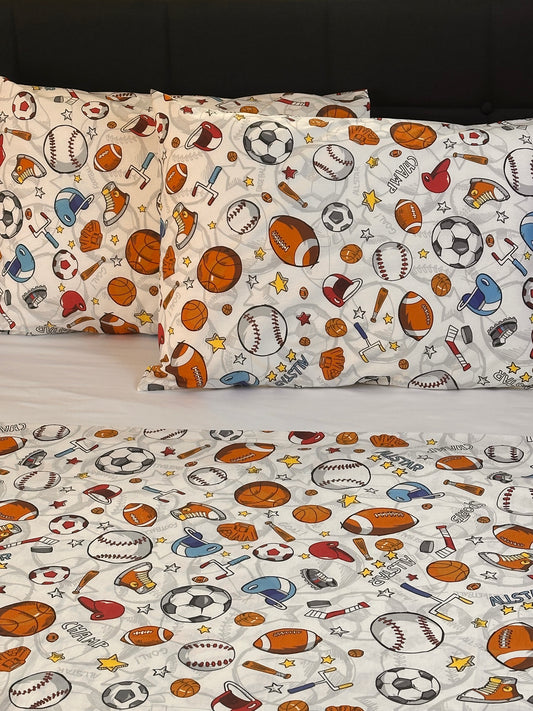 Curtains with sports-themed pattern featuring balls and equipment on a white background.
