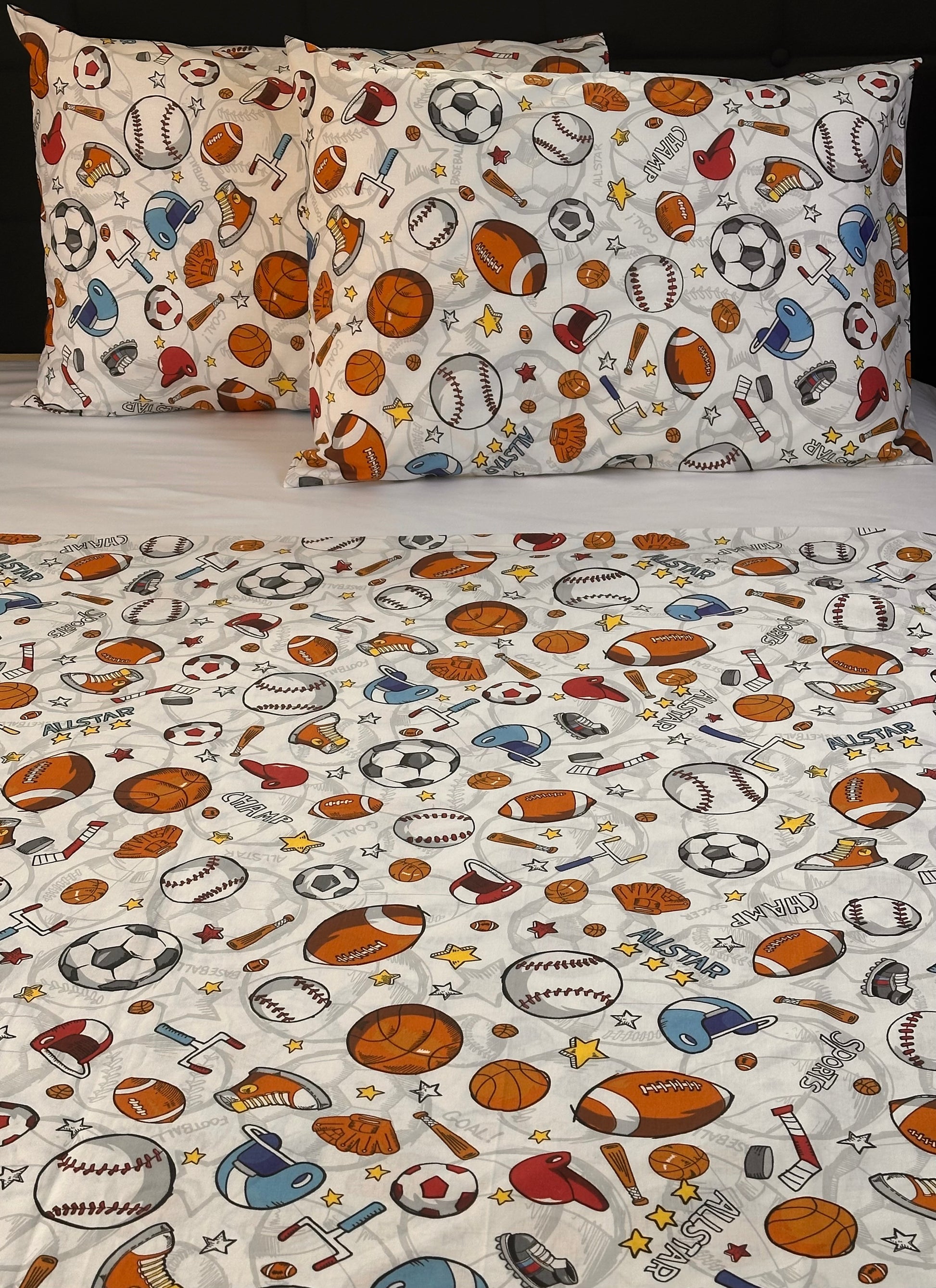 Sheet set with sports-themed design featuring balls and equipment on a white background.