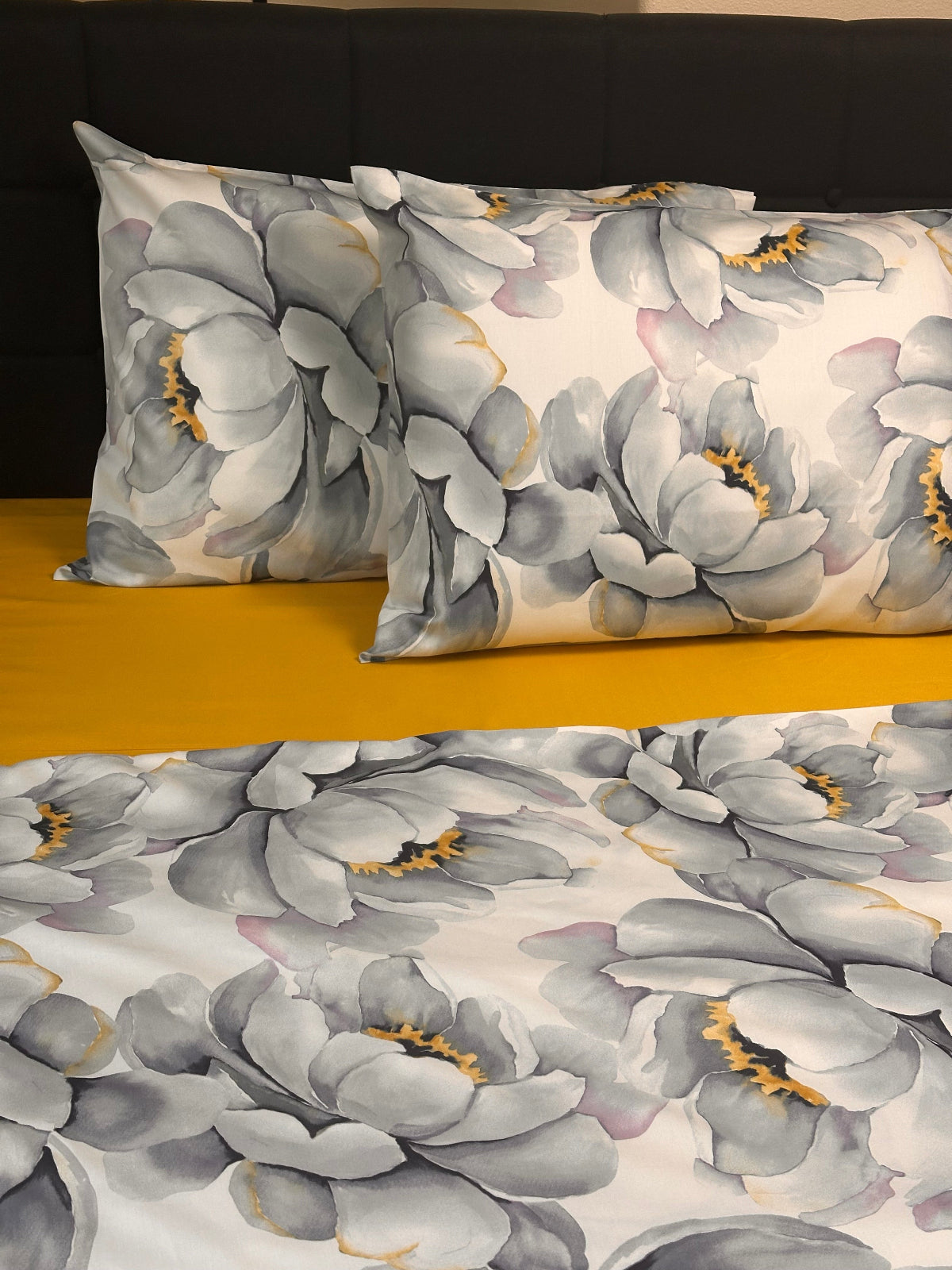 Floral patterned fabric with gray flowers on a white background