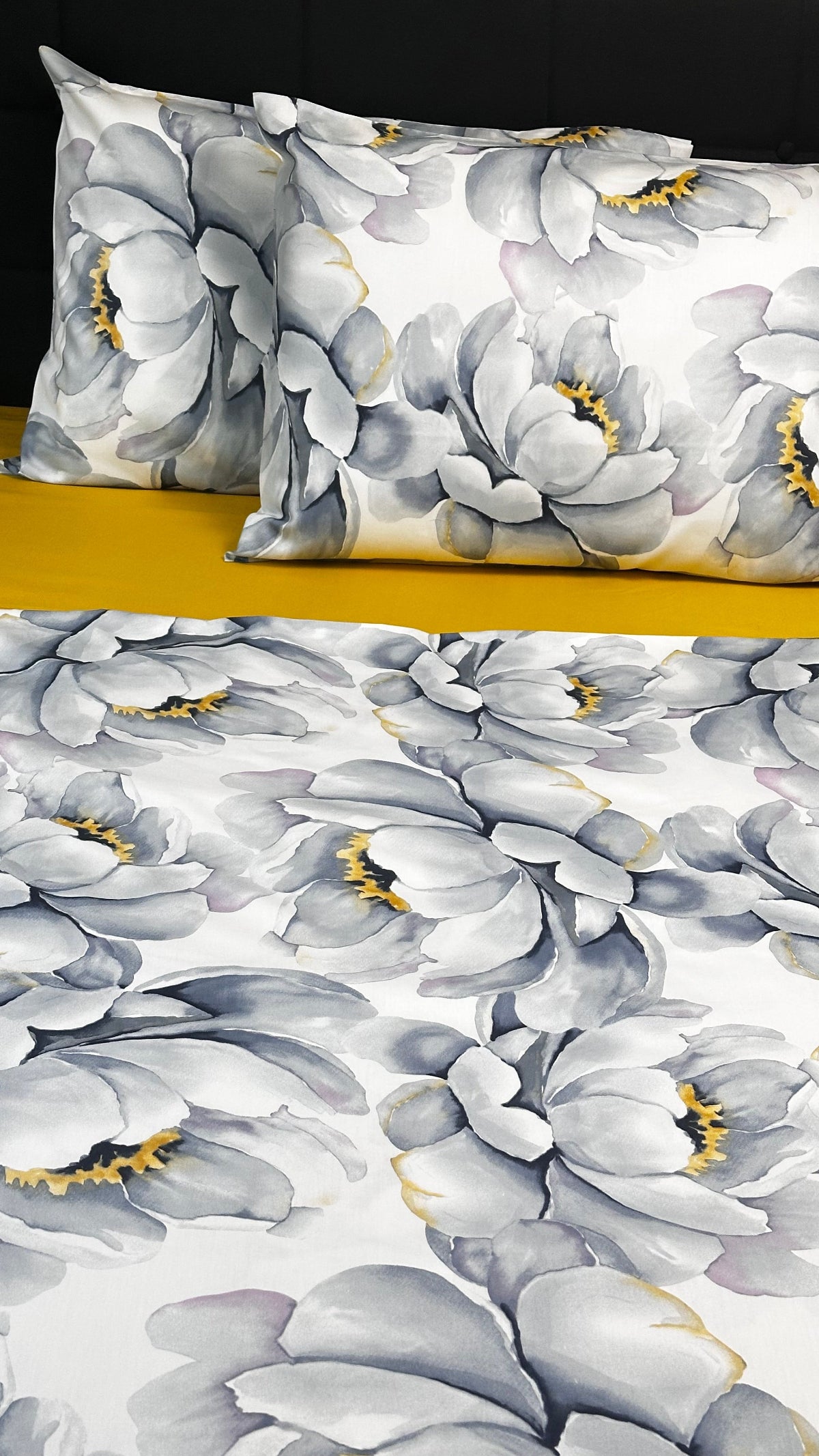 Floral patterned pillow and fabric swatch on a plain background