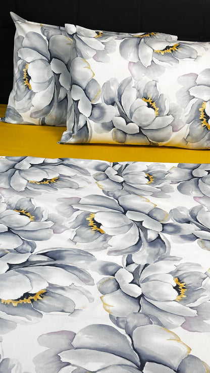 Floral patterned pillow and fabric swatch on a plain background