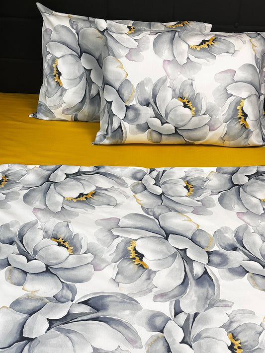 Elegant bedding set featuring oversized gray and yellow peony print pillowcases and duvet cover.