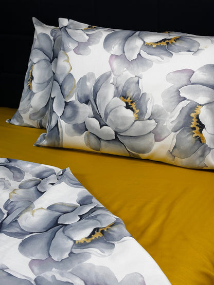 Floral patterned pillows on a mustard yellow background