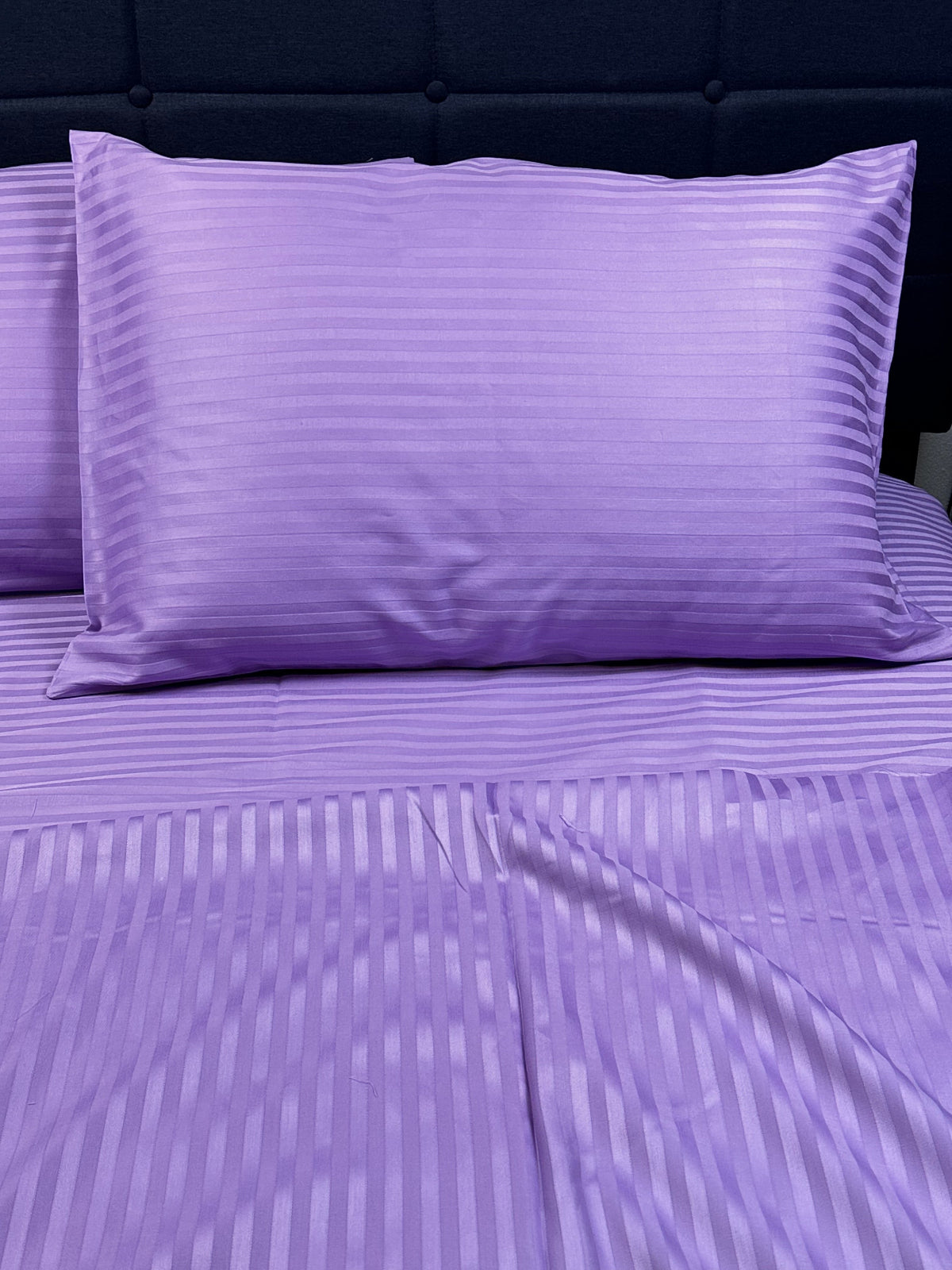 Close-up of lavender striped pillowcase – silky smooth organic cotton weave