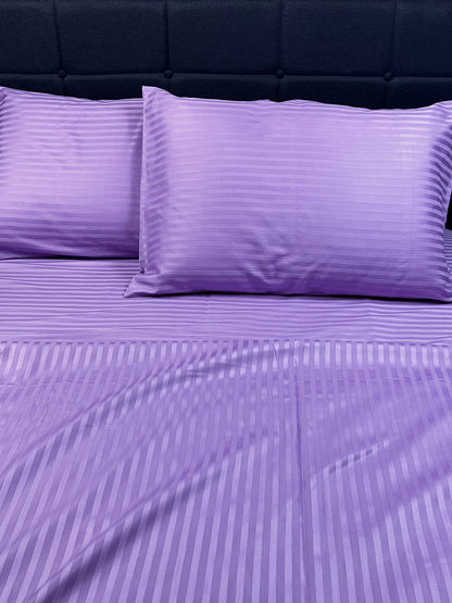 Lavender stripe sateen bedding styled on bed — soft cotton, cooling and elegant.
