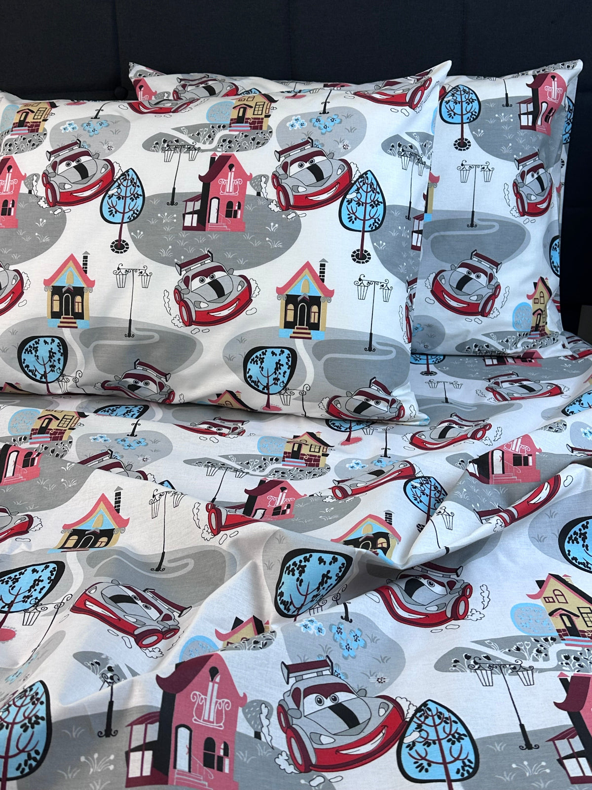 Organic cotton pillowcase featuring fun car illustrations — lightweight, breathable kids bedding