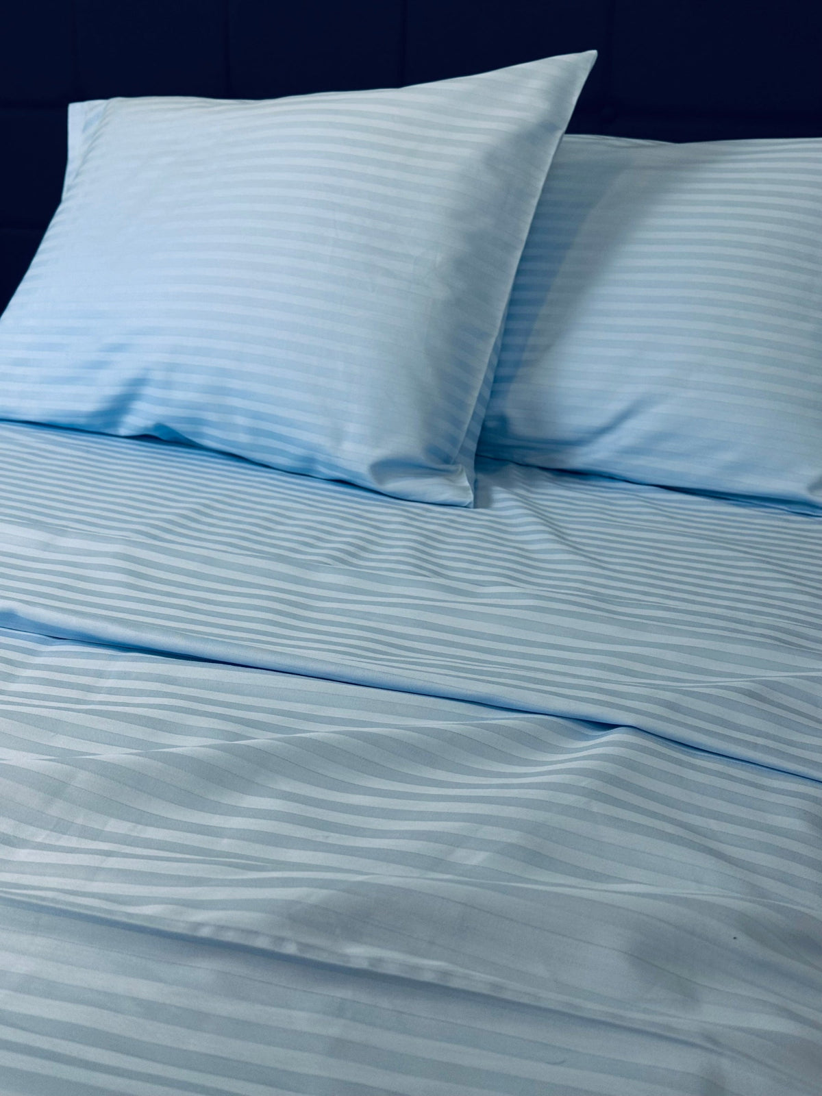 Hypoallergenic blue stripe bedding set displayed in a modern bedroom