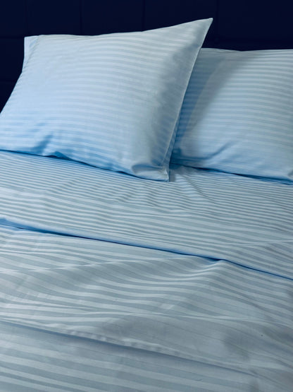 Hypoallergenic blue stripe bedding set displayed in a modern bedroom