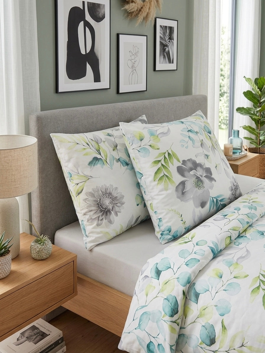 Bedroom with floral bedding and pillows, wooden nightstands, and framed art on the wall.