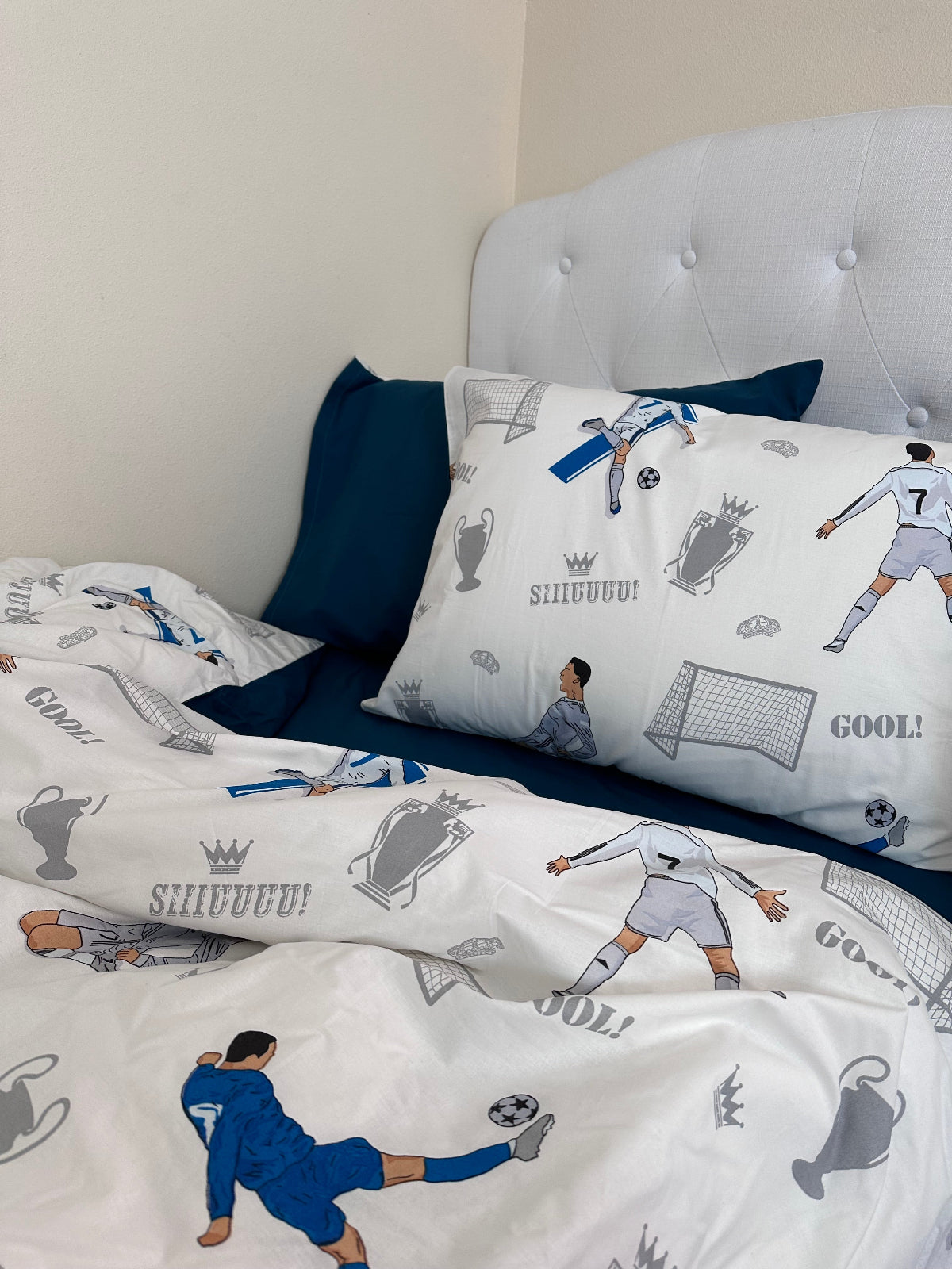Soccer-themed kids pillowcase featuring athlete illustration and playful blue design